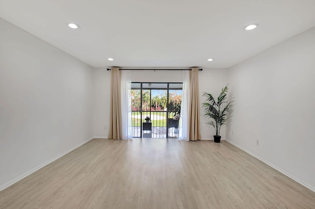 unfurnished room with light hardwood / wood-style floors