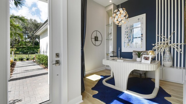 bathroom with hardwood / wood-style flooring and a chandelier