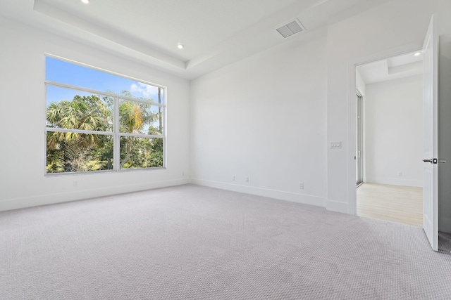 359 SE Via Sangro, Port Saint Lucie, FL 34952 - empty room with light carpet, baseboards, recessed lighting, and a tray ceiling