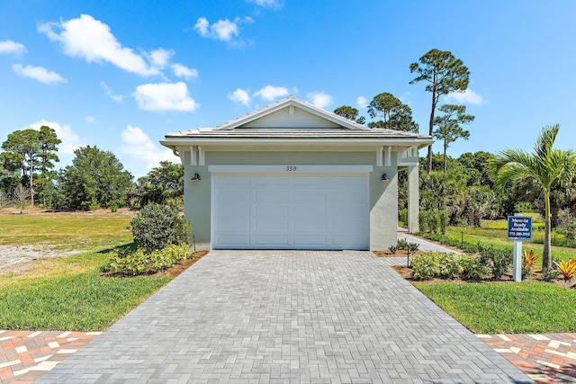 359 SE Via Sangro, Port Saint Lucie, FL 34952 - view of front of home with stucco siding, decorative driveway, a front lawn, and a garage