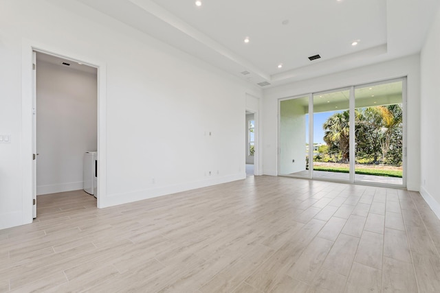 359 SE Via Sangro, Port Saint Lucie, FL 34952 - unfurnished room with light wood finished floors, a tray ceiling, recessed lighting, and baseboards