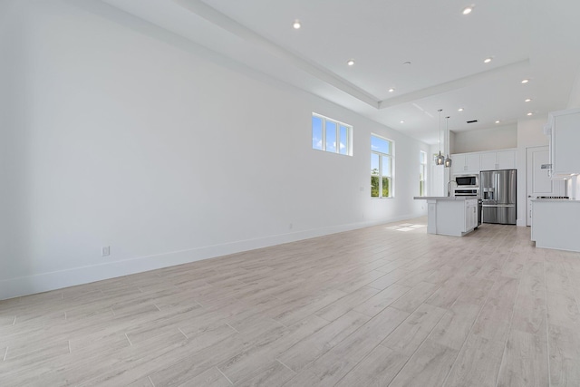 359 SE Via Sangro, Port Saint Lucie, FL 34952 - unfurnished living room with light wood finished floors, baseboards, and recessed lighting