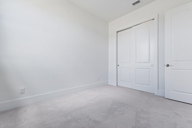 359 SE Via Sangro, Port Saint Lucie, FL 34952 - unfurnished bedroom featuring light carpet, a closet, and baseboards