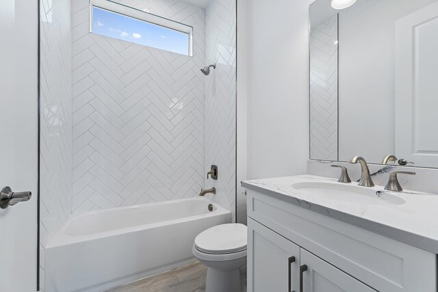 359 SE Via Sangro, Port Saint Lucie, FL 34952 - bathroom with toilet, shower / bath combination, vanity, and wood finished floors