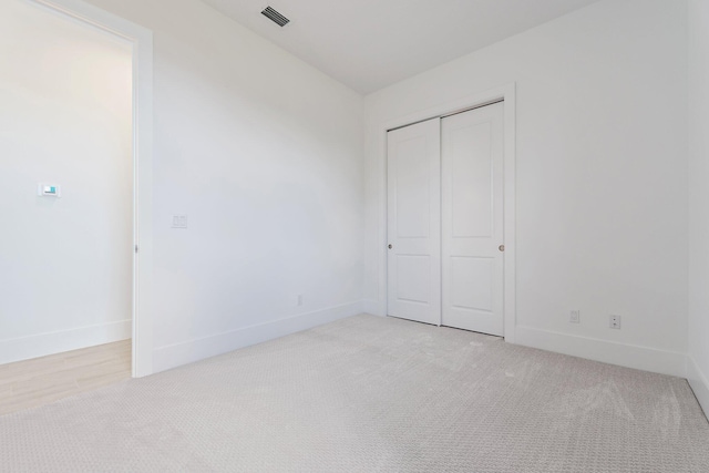 359 SE Via Sangro, Port Saint Lucie, FL 34952 - unfurnished bedroom featuring light carpet, baseboards, and a closet