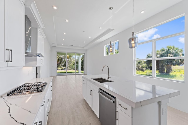 359 SE Via Sangro, Port Saint Lucie, FL 34952 - kitchen with a sink, appliances with stainless steel finishes, light wood-style flooring, wall chimney range hood, and recessed lighting