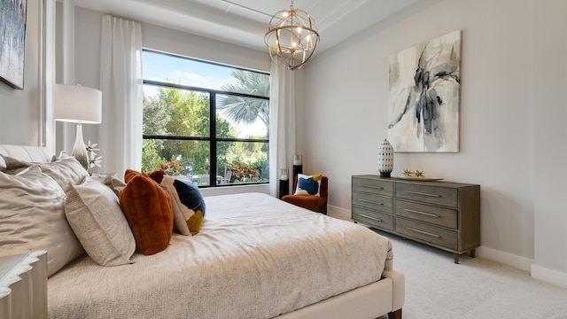 bedroom featuring light carpet, an inviting chandelier, and multiple windows