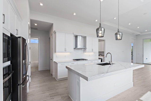 359 SE Via Sangro, Port Saint Lucie, FL 34952 - kitchen with a sink, wall chimney exhaust hood, stainless steel fridge, gas stovetop, and light wood-style flooring