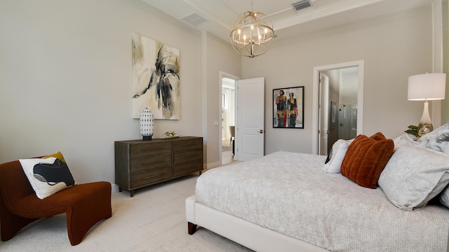 bedroom featuring ensuite bath, light colored carpet, and an inviting chandelier