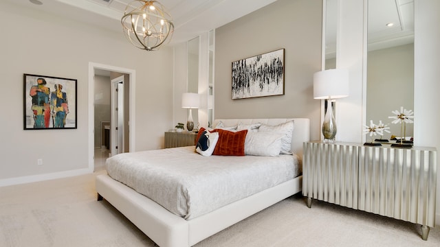 bedroom with carpet, a chandelier, and ensuite bath