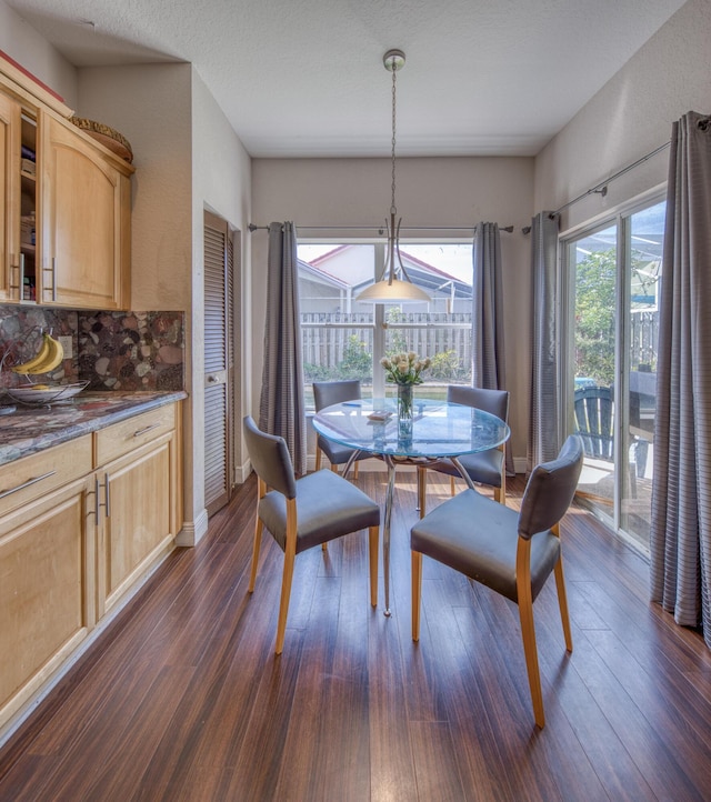 dining room with dark wood-style floors and baseboards