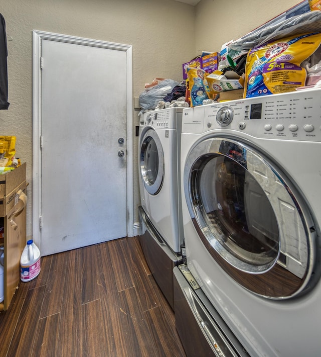 washroom featuring dark hardwood / wood-style flooring and separate washer and dryer