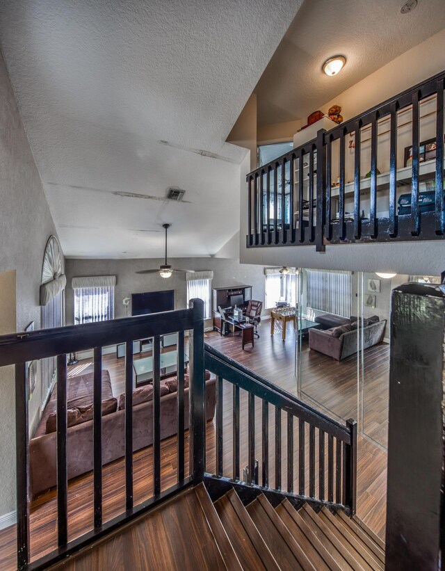 bedroom with vaulted ceiling, carpet, and a textured ceiling