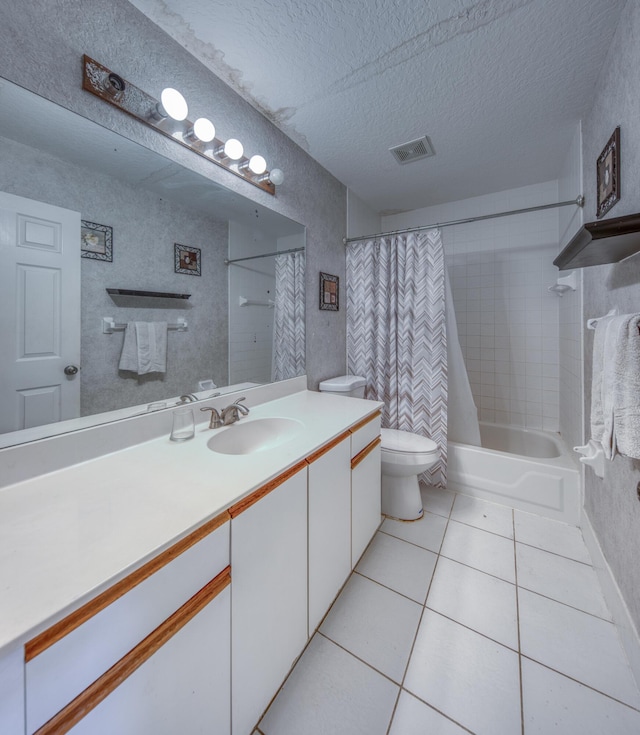 full bathroom with shower / bathtub combination with curtain, vanity, a textured ceiling, tile patterned floors, and toilet