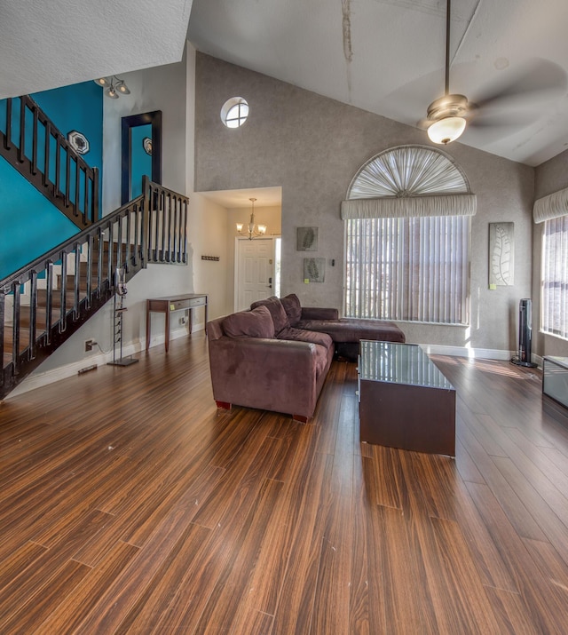 living room featuring high vaulted ceiling, dark hardwood / wood-style floors, and a chandelier