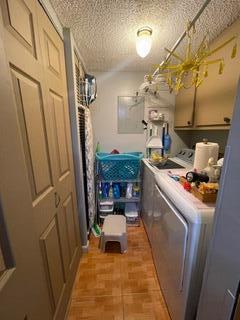 laundry room featuring cabinets and washing machine and clothes dryer