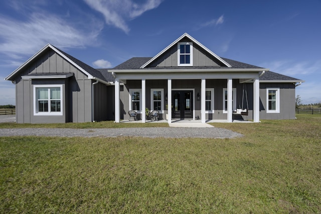 rear view of property with a yard