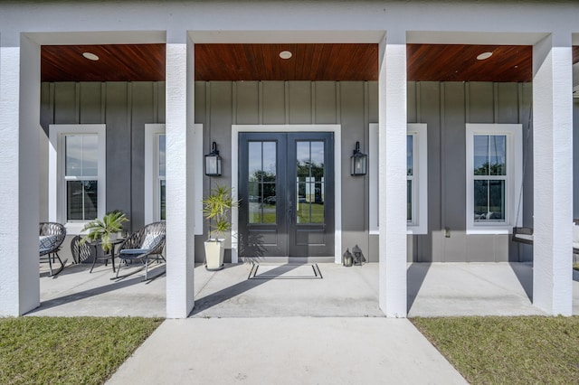 property entrance featuring french doors and covered porch