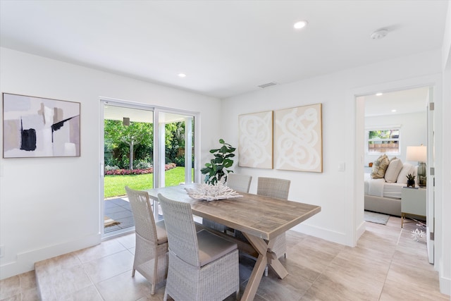 tiled dining room with a healthy amount of sunlight