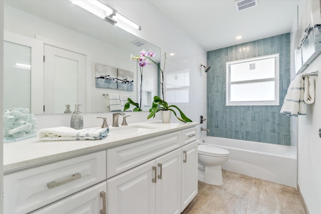 full bathroom featuring toilet, tiled shower / bath combo, and vanity