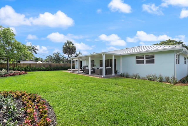 back of house with an outdoor hangout area, a patio area, and a yard