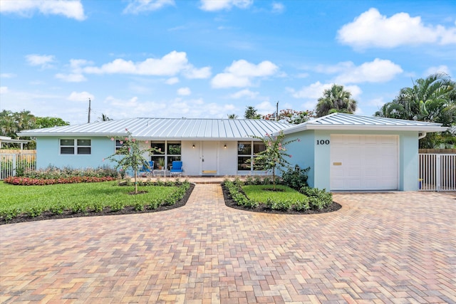 ranch-style home featuring a garage