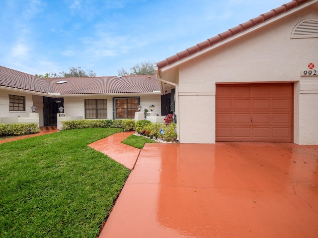 view of front of house featuring a garage and a front lawn