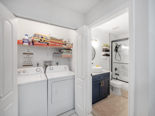 laundry area with sink and separate washer and dryer