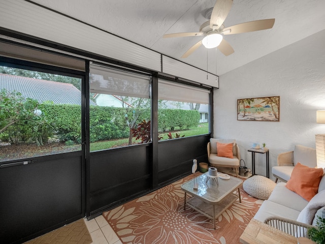 living room with ceiling fan, a textured ceiling, light tile patterned floors, and vaulted ceiling