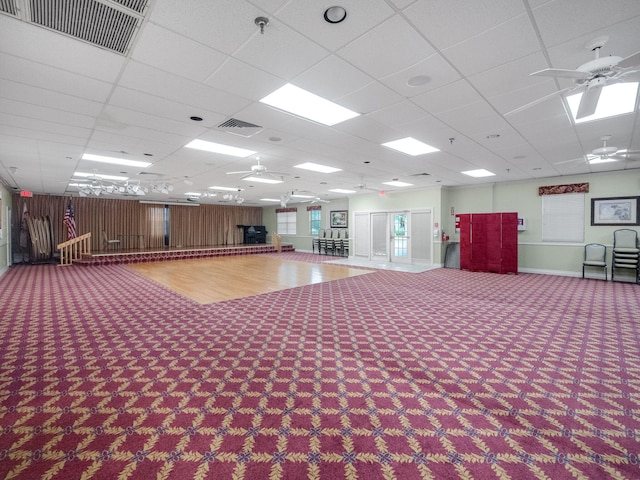 miscellaneous room with ceiling fan, a paneled ceiling, and carpet floors