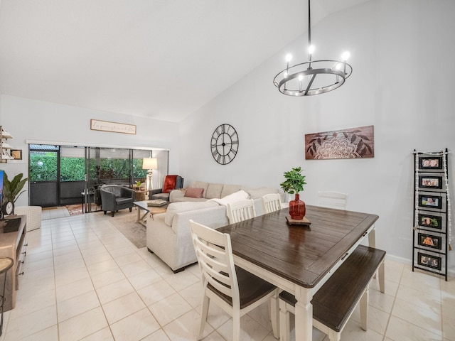 tiled dining area featuring high vaulted ceiling and a notable chandelier