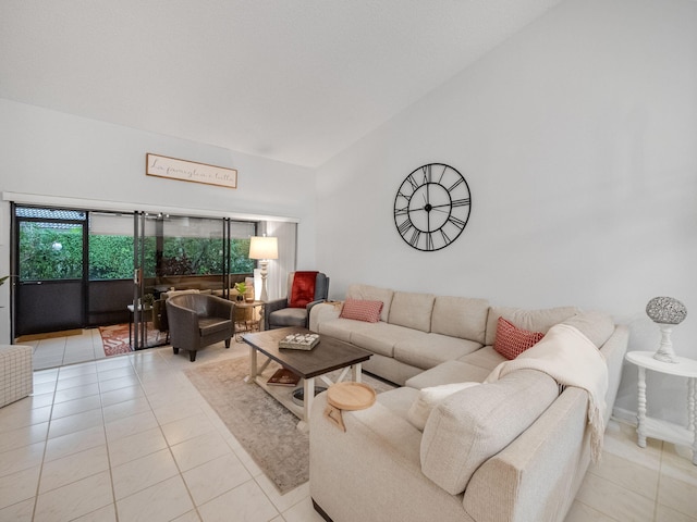 tiled living room featuring a towering ceiling