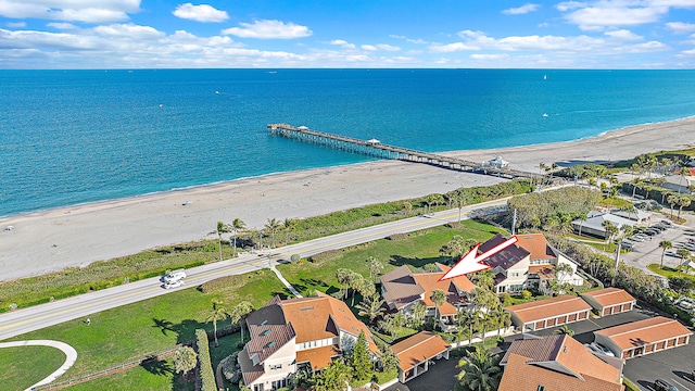 birds eye view of property with a view of the beach and a water view