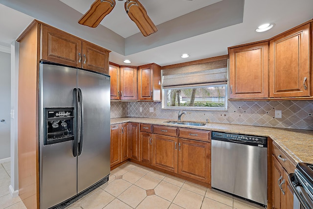 kitchen featuring sink, light tile patterned floors, ceiling fan, stainless steel appliances, and decorative backsplash