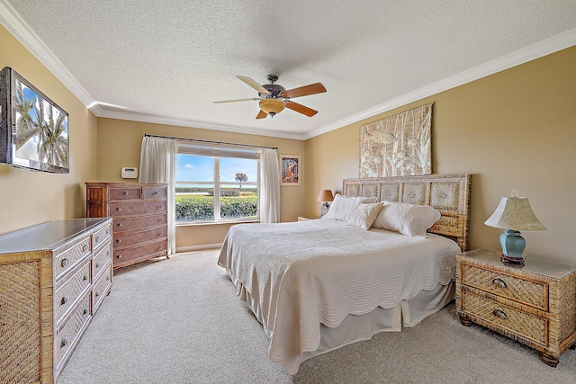 bedroom featuring light carpet, a textured ceiling, ornamental molding, and ceiling fan