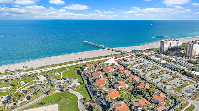 bird's eye view with a water view and a beach view