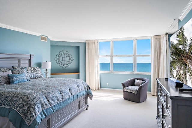 carpeted bedroom featuring ornamental molding, visible vents, a water view, and baseboards