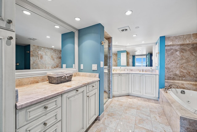 bathroom featuring visible vents, a tub with jets, a tile shower, vanity, and recessed lighting