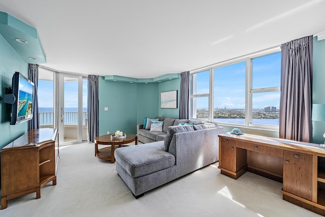 living room with a water view and light carpet