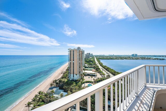 view of swimming pool featuring a water view and a view of the beach