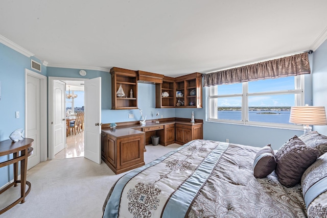 carpeted bedroom featuring crown molding, a water view, and built in desk