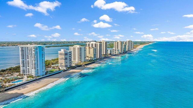 aerial view with a water view and a view of the beach