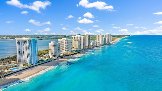 aerial view with a water view, a view of city, and a view of the beach