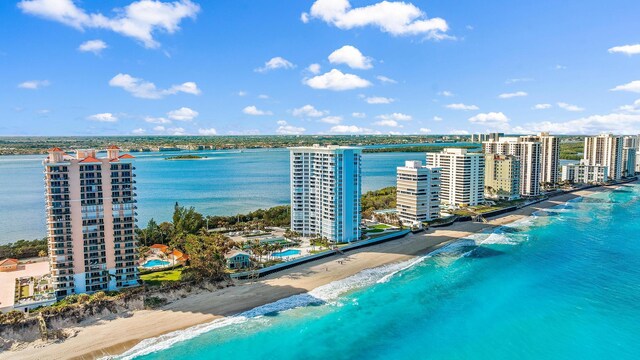 drone / aerial view featuring a beach view and a water view