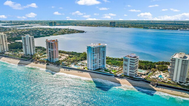 drone / aerial view with a view of the beach, a water view, and a city view