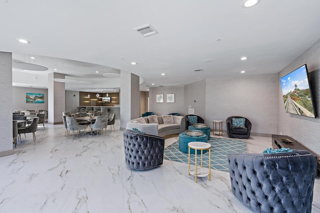 living room with marble finish floor, visible vents, and recessed lighting