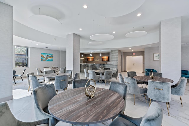 dining area with marble finish floor and recessed lighting