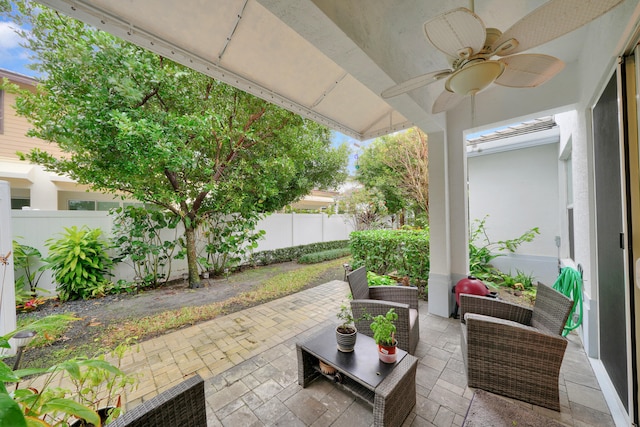 view of patio featuring an outdoor hangout area, a fenced backyard, and a ceiling fan