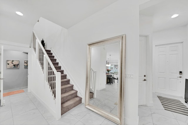 entrance foyer featuring stairs, marble finish floor, recessed lighting, and baseboards