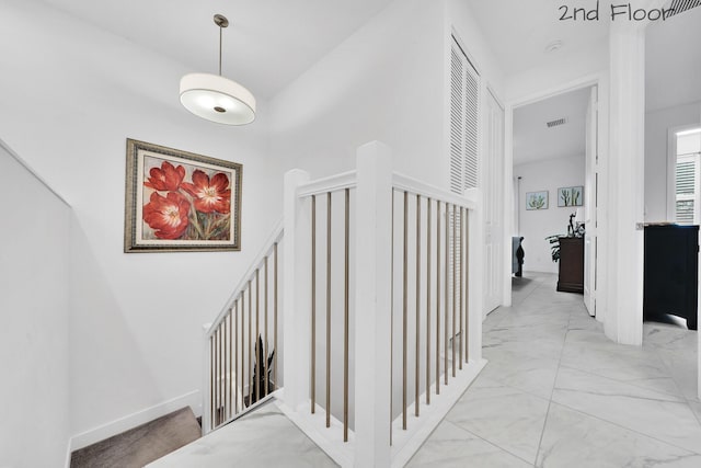 corridor with marble finish floor and visible vents